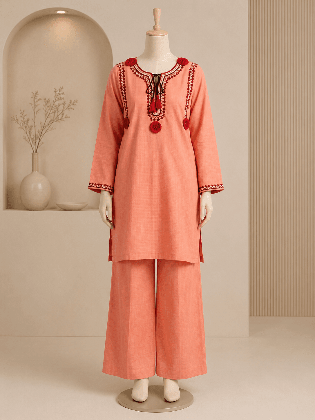 Gulnar coral kurta set styled in a warm festive interior